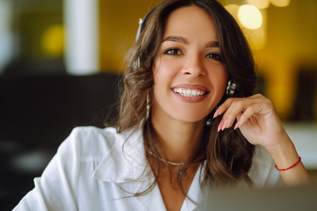 Young operator woman agent with headsets working in a call centre. Call center service.